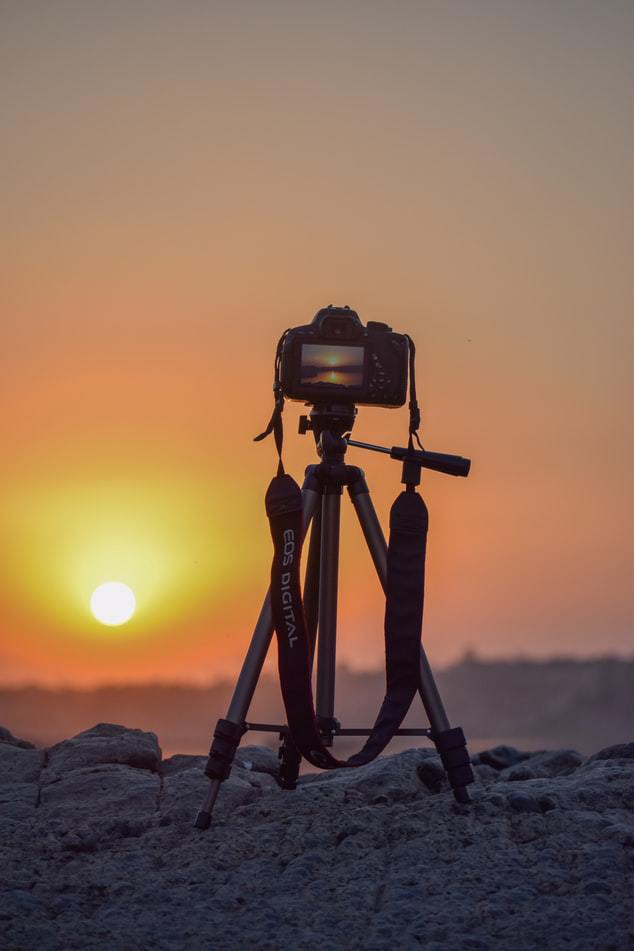 Camera on tripod having sunset shots