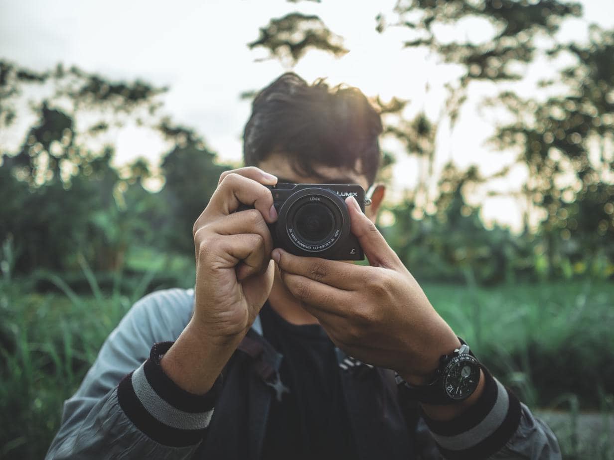 Man uses a Panasonic DMC-GX8 camera to take photos