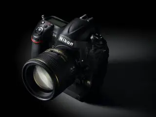 black nikon camera with on a black surface