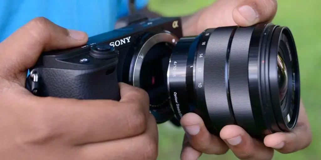 Man installing the new the Sony A6500 camera lens.
