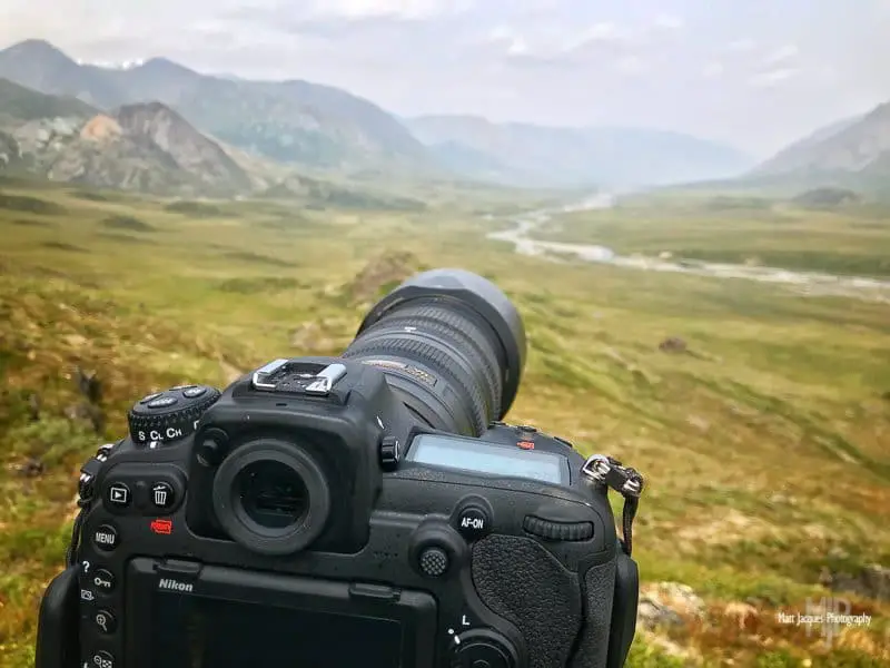 black camera in a mountain scenery
