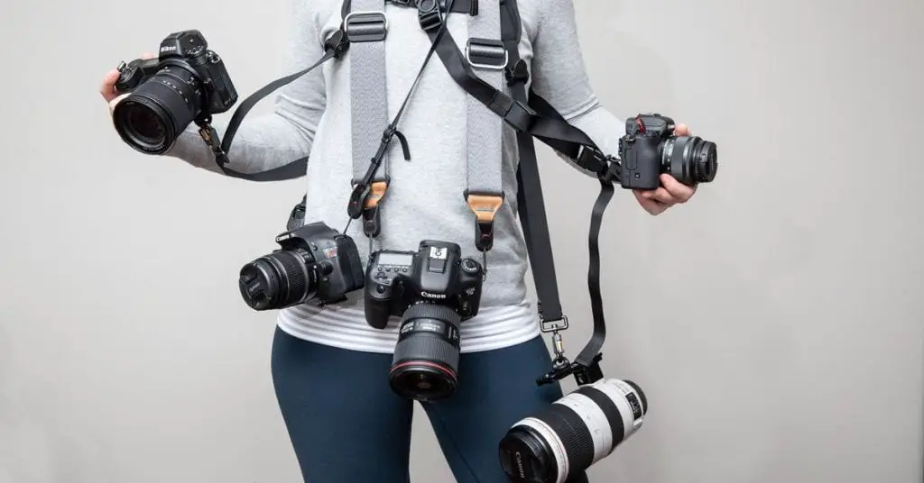 Woman with multiple cameras hanging around her neck