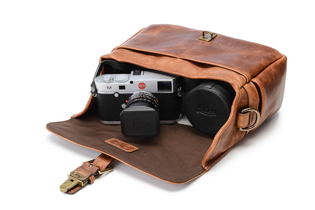 Ona leather bowery bag contains a camera, lenses, and accessories.