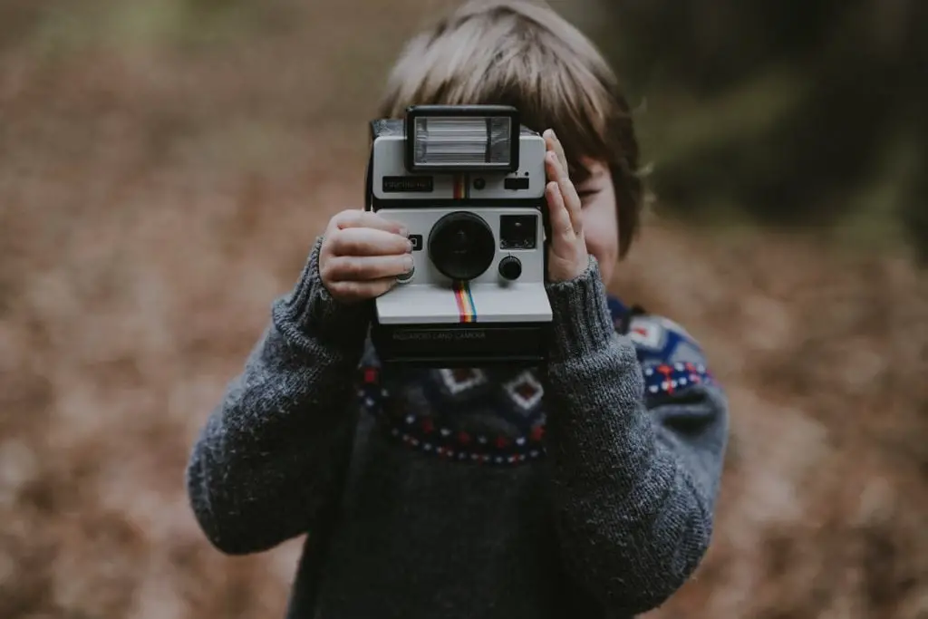 A child with a Polaroid camera