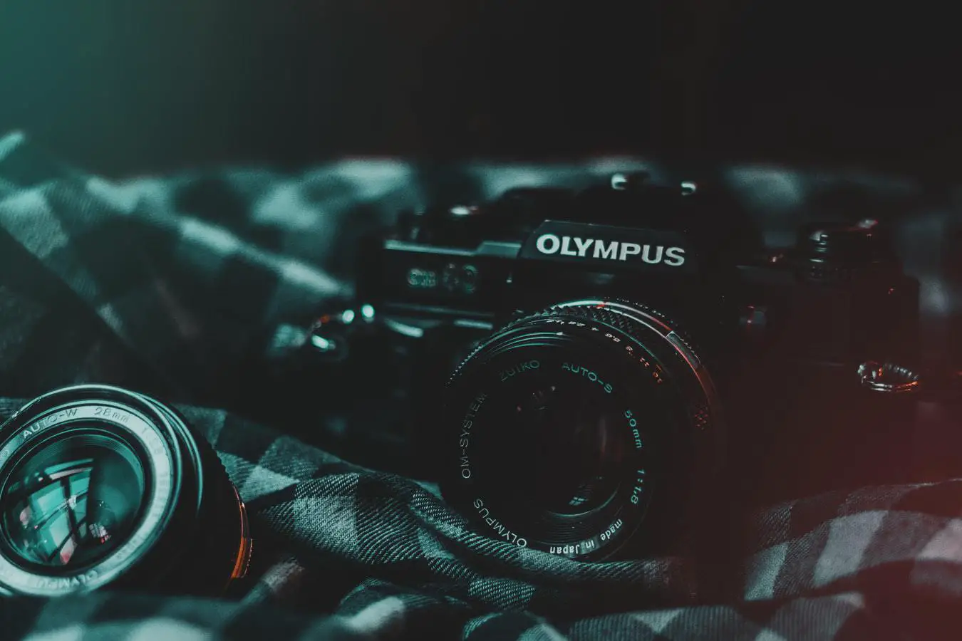 black olympus camera on a black checkered