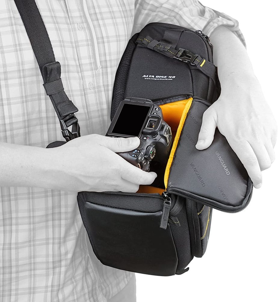 Man takes out his digital camera from his sling bag