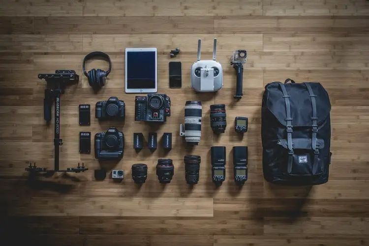 Photographer's travel kit arranged in the wooden floor