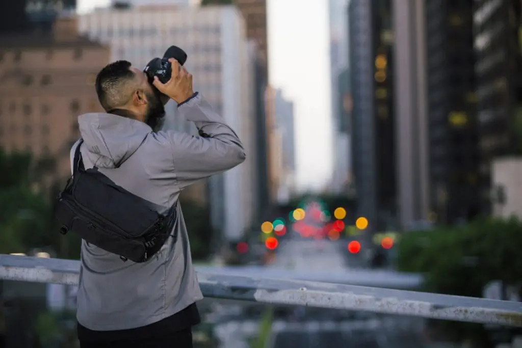 Man uses his digital camera to photograph a building