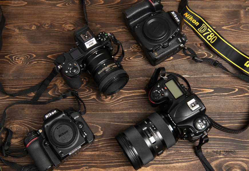 A flat lay photo of different Nikon cameras