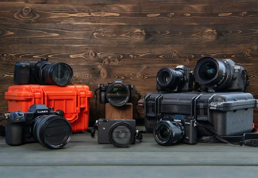 Collection of various types of cameras arranged on a table