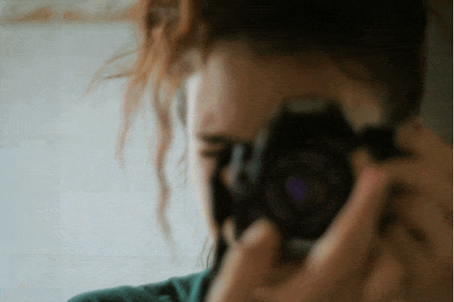 Girl adjusting her lens to focus