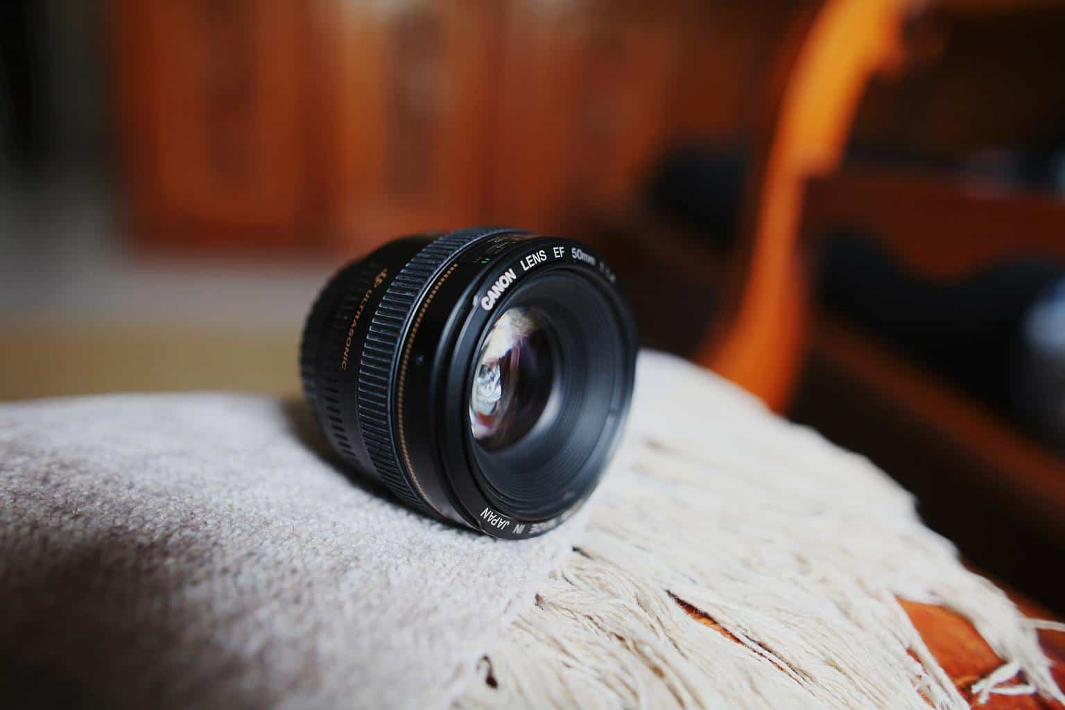 Canon 50mm lens placed on a blanket