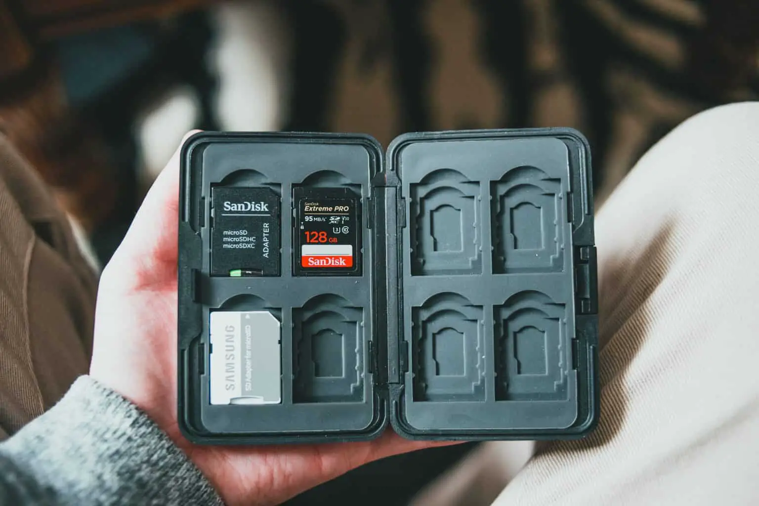 A man holding a case for memory cards