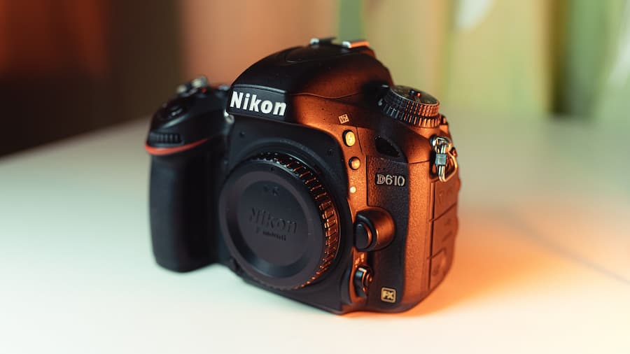 Black nikon camera on a white surface