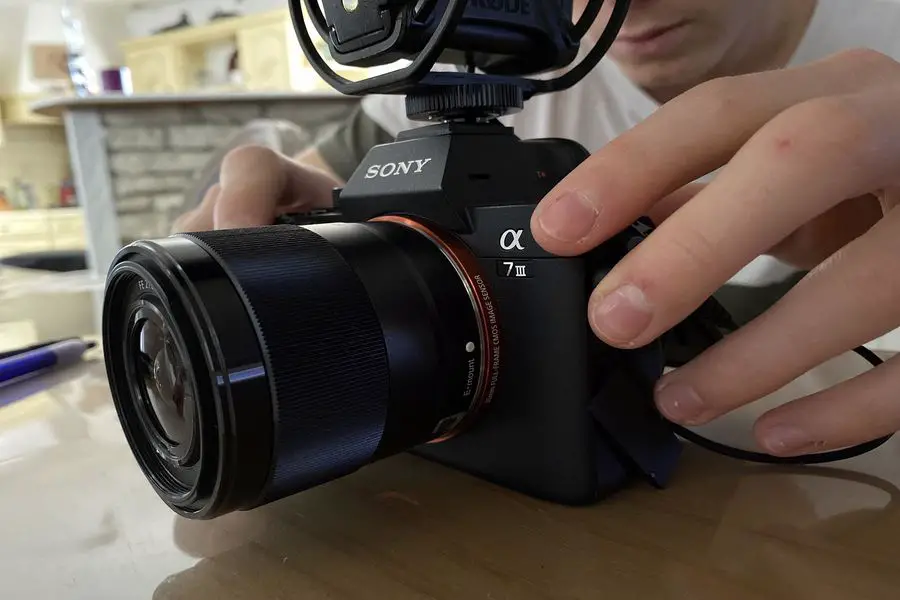 Person trying to clean a Sony a7 III's sensor
