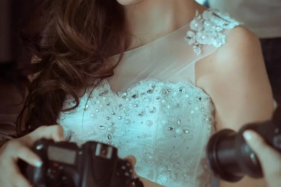 An image of a bride holding a camera