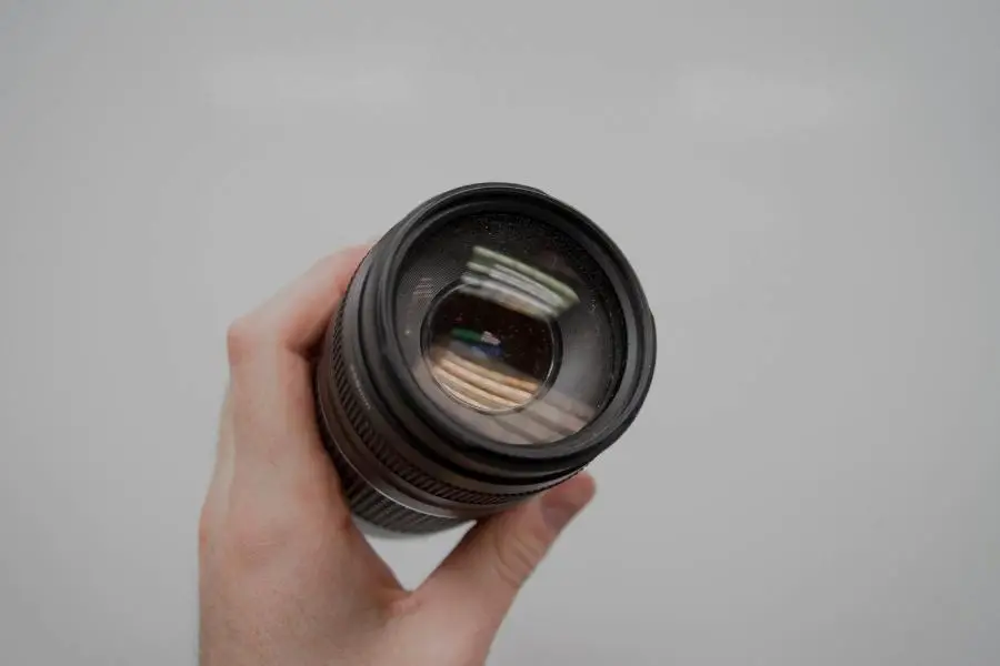 An image of a person holding lens