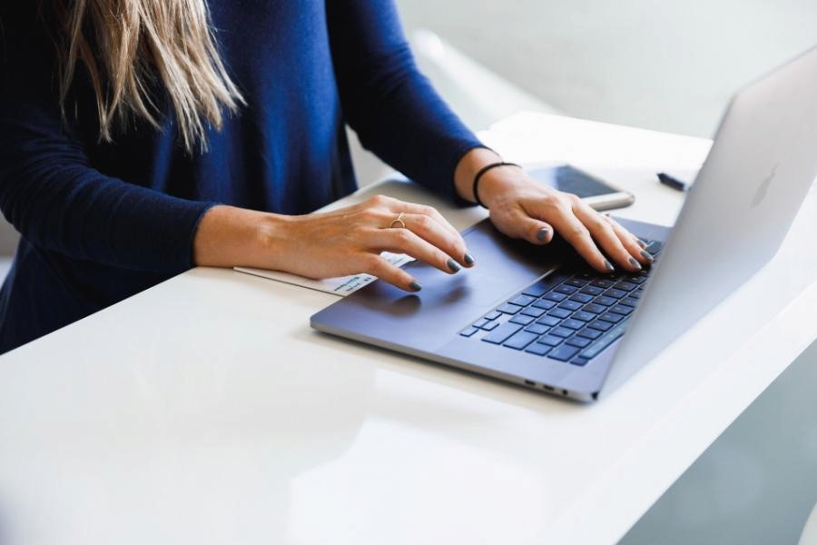 An image of a person working on her laptop